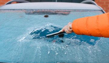 Person,Scraping,Ice,Off,Windshield,Of,Car,In,Winter