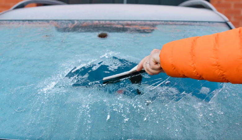 Person,Scraping,Ice,Off,Windshield,Of,Car,In,Winter